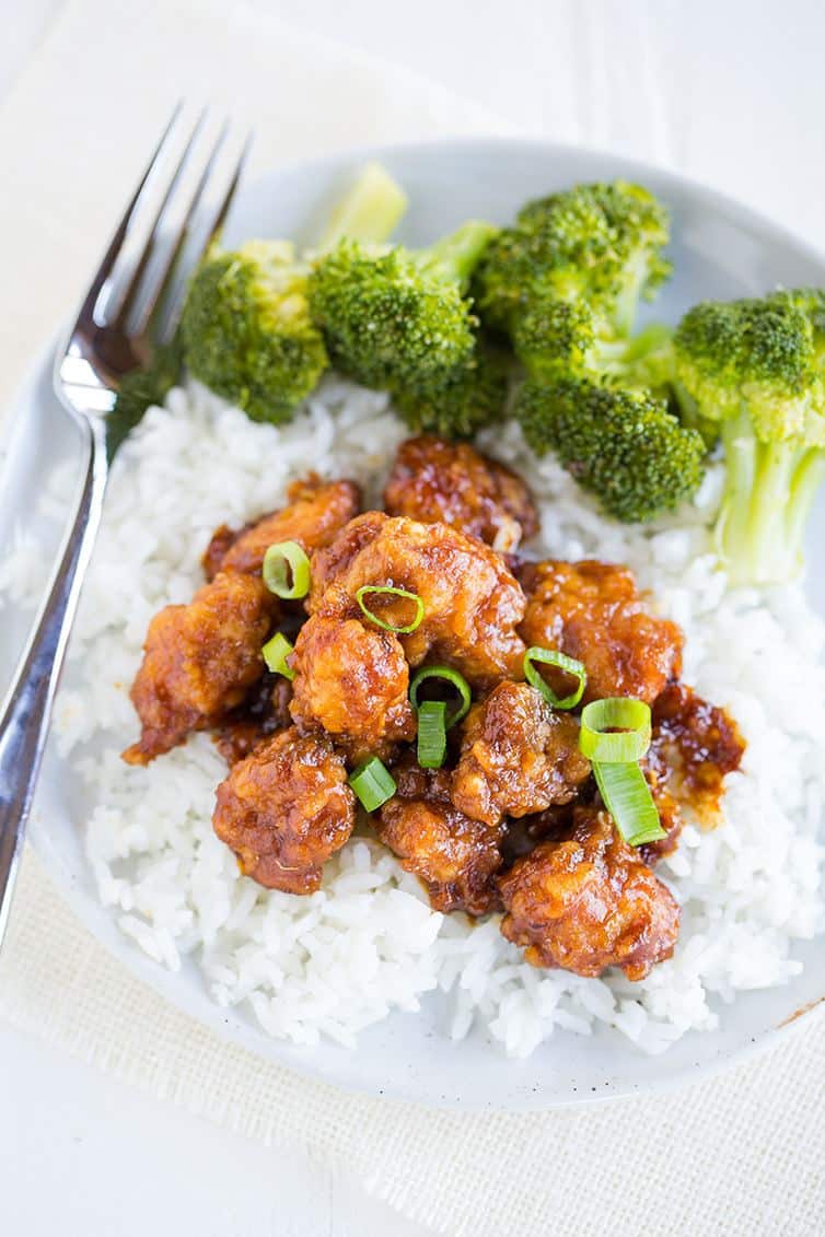 Homemade General Tso's Chicken over white rice with steamed broccoli