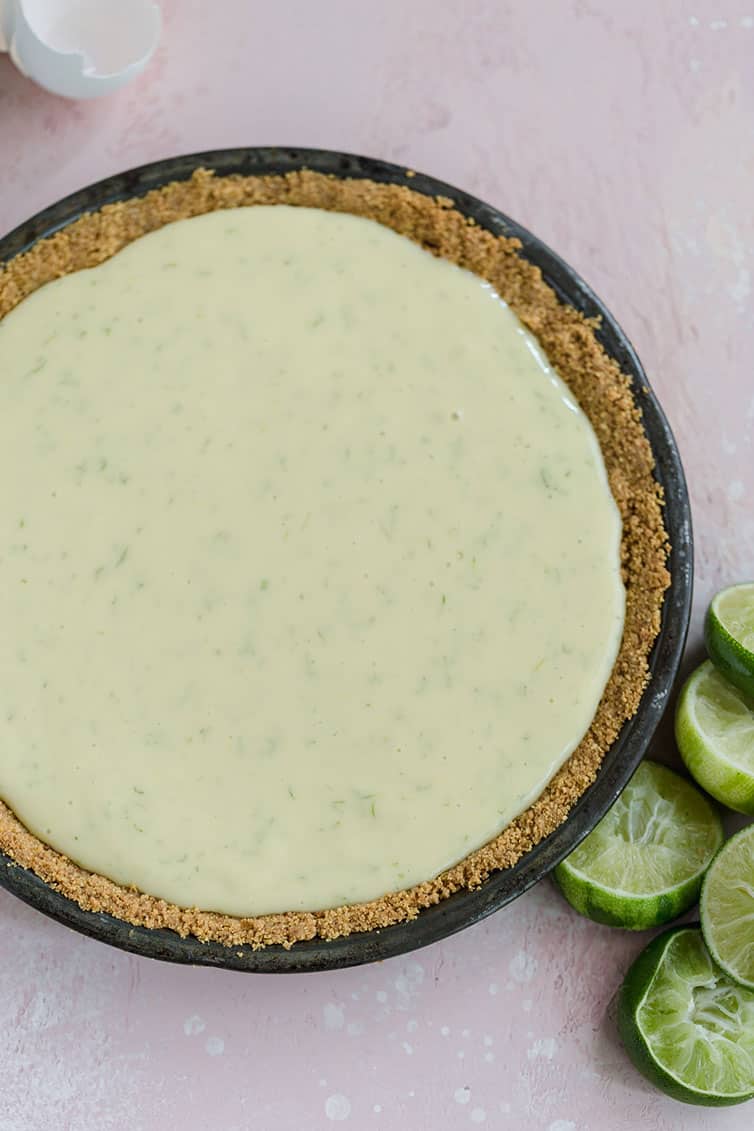 Key lime pie filling poured into a graham cracker crust.