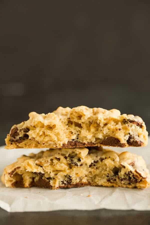 A thick and chewy oatmeal chocolate chip cookie broken in half.