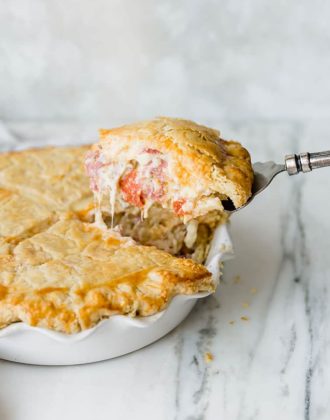 A slice of Italian Easter Pie being lifted out of the pie plate.