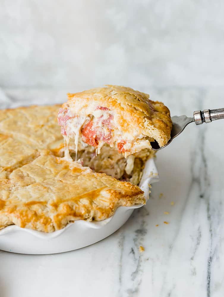 A slice of Italian Easter Pie being lifted out of the pie plate.