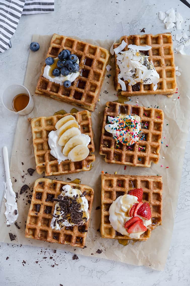Six waffles with various toppings.