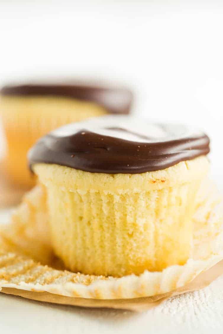 Boston Cream Cupcakes - Vanilla cupcakes filled with pastry cream and topped with chocolate ganache.