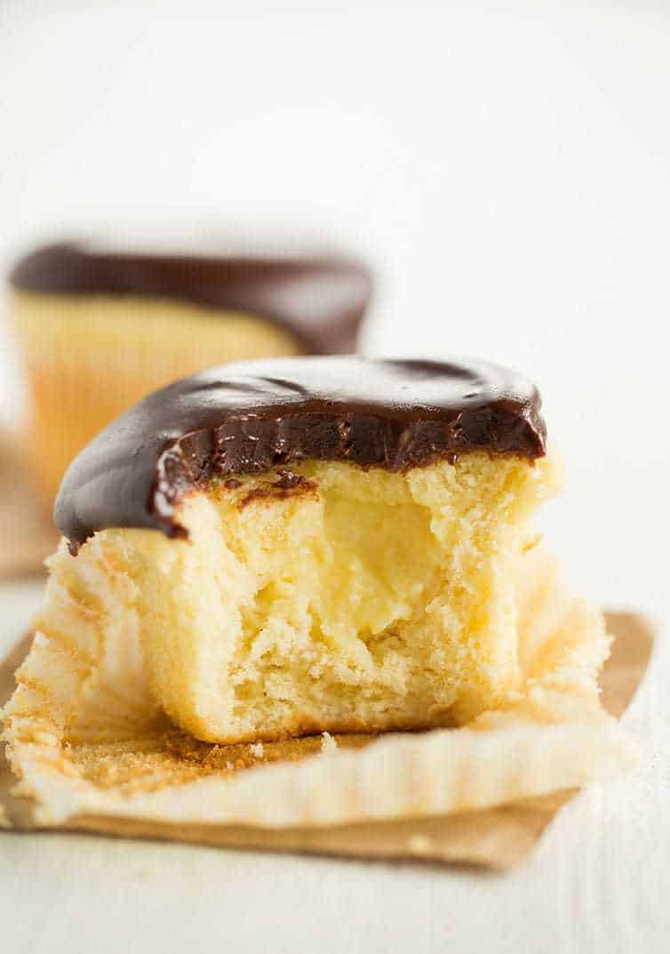 Boston Cream Cupcakes - Vanilla cupcakes filled with pastry cream and topped with chocolate ganache.