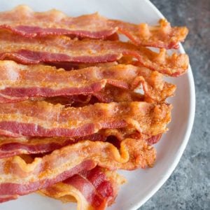 A plate with slices of oven baked bacon.