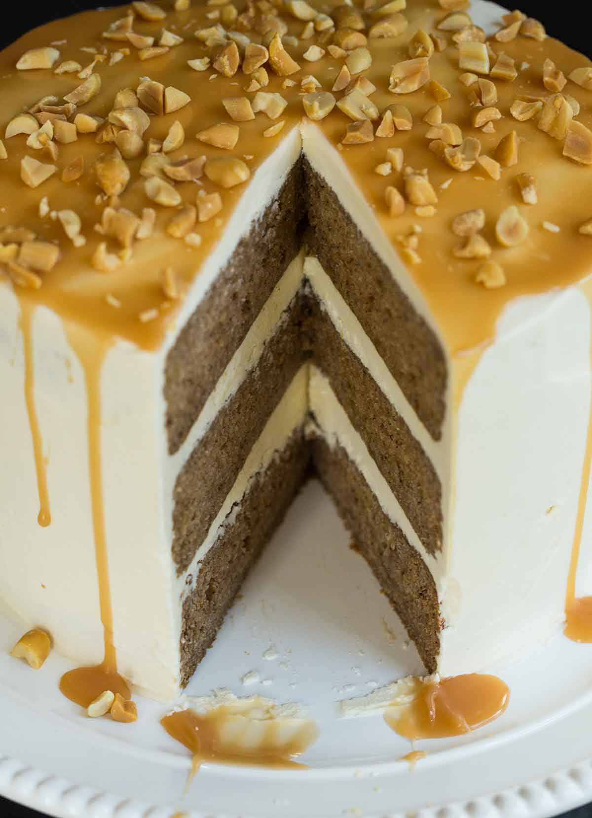 Closeup photo of salted caramel apple cake with a slice removed.