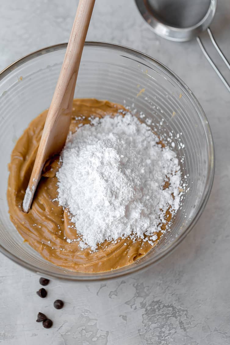 Peanut butter and powdered sugar mixture in a glass bowl.