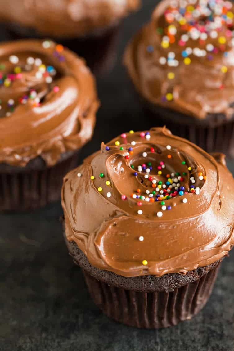 Chocolate cupcakes with a silky smooth chocolate frosting and sprinkles.