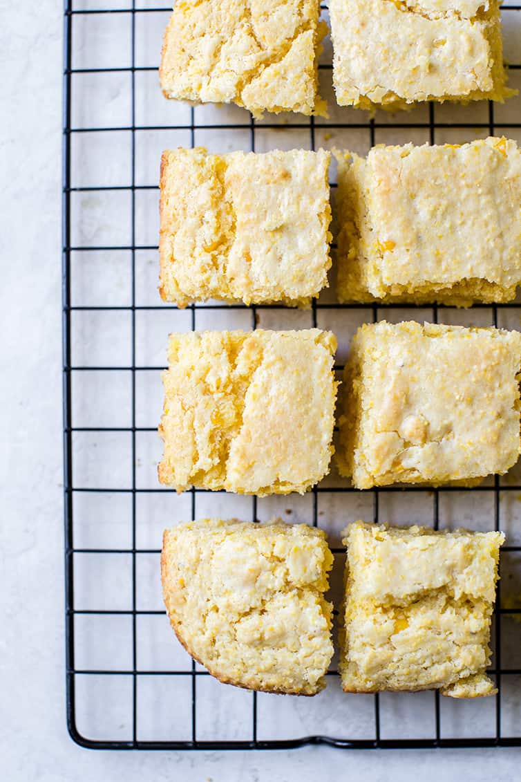 Squares of cornbread on a wire cooling rack.