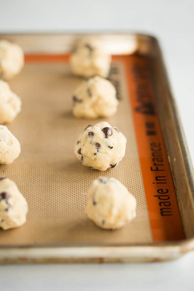 Balls of cookie dough on a baking sheet.