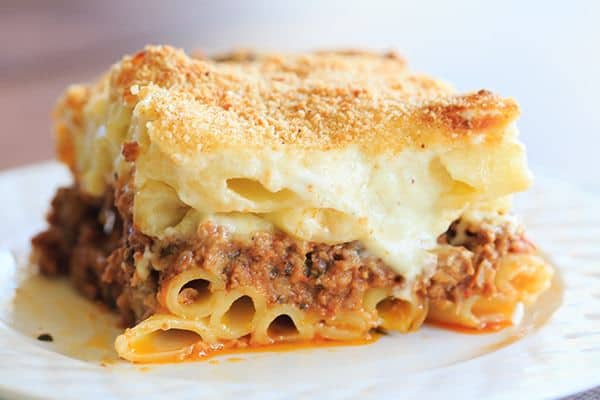 A classic pastitsio recipe - layers of ziti pasta with a beef and lamb sauce, bechamel and loads of cheese! | https://www.browneyedbaker.com/pastitsio-recipe/