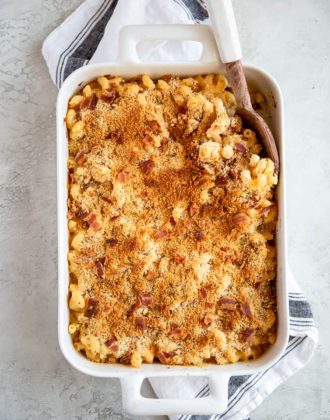 A white casserole dish with baked mac and cheese