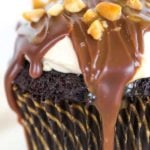 These Snickers cupcakes taste JUST like the candy bar... A chocolate cupcake filled with peanut nougat, topped with a caramel buttercream frosting, covered in a chocolate ganache, chopped peanuts and a drizzle of caramel sauce.