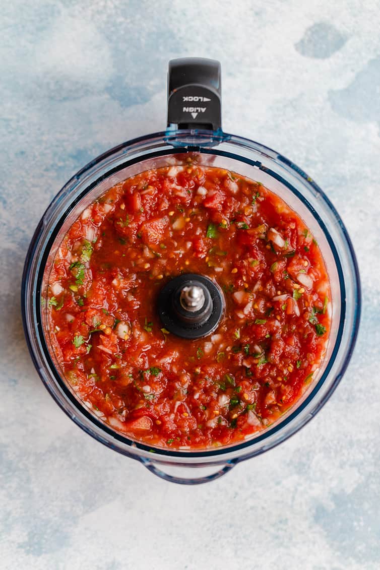An overhead shot of the prepared salsa still in the food processor.