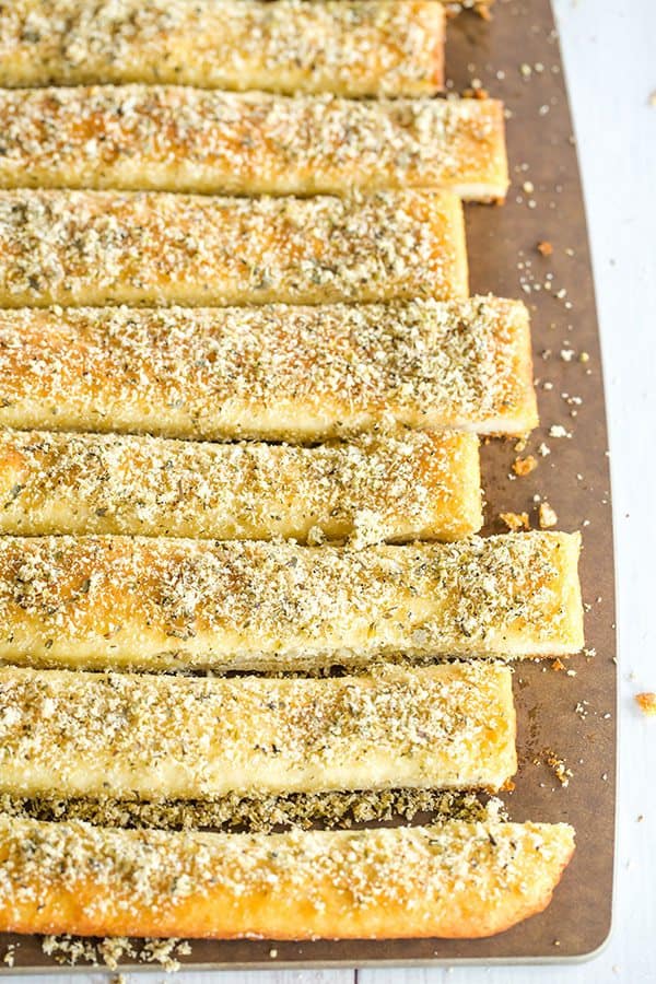 A copycat recipe for Pizza Hut breadsticks, made from scratch. Chewy, buttery, loaded with seasonings and an easy dipping sauce!