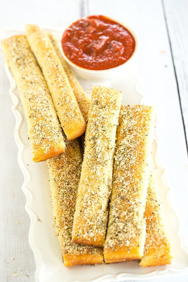A copycat recipe for Pizza Hut breadsticks, made from scratch. Chewy, buttery, loaded with seasonings and an easy dipping sauce!