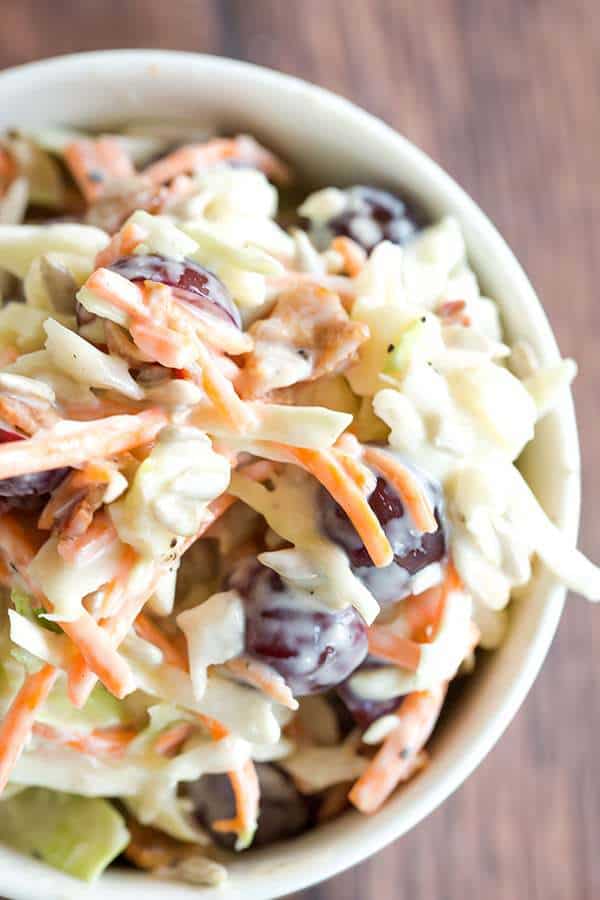 A loaded cole slaw recipe loaded with cheese, bacon, grapes, and sunflower seeds. A great addition to your summer picnic!