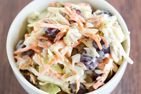 A loaded cole slaw recipe loaded with cheese, bacon, grapes, and sunflower seeds. A great addition to your summer picnic!