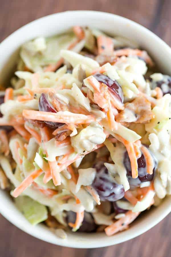 A loaded cole slaw recipe loaded with cheese, bacon, grapes, and sunflower seeds. A great addition to your summer picnic!