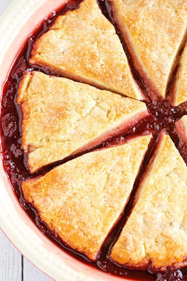 Cobbler-style biscuits are nestled on top of fresh strawberry jam and baked until bubbling and golden. A wonderful summer dessert!