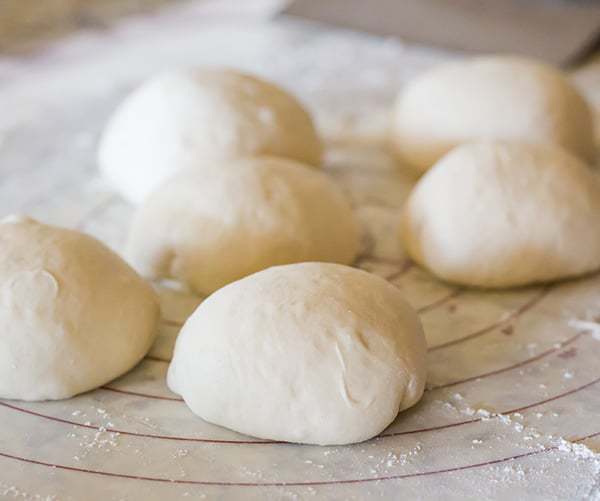 This Neapolitan pizza crust is thin, crispy and has the most amazing flavor. My homemade pizza-making is forever changed!