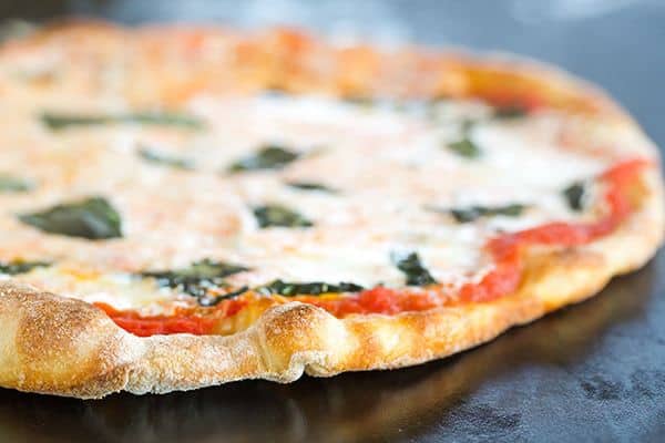 This Neapolitan pizza crust is thin, crispy and has the most amazing flavor. My homemade pizza-making is forever changed!