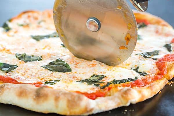 This Neapolitan pizza crust is thin, crispy and has the most amazing flavor. My homemade pizza-making is forever changed!