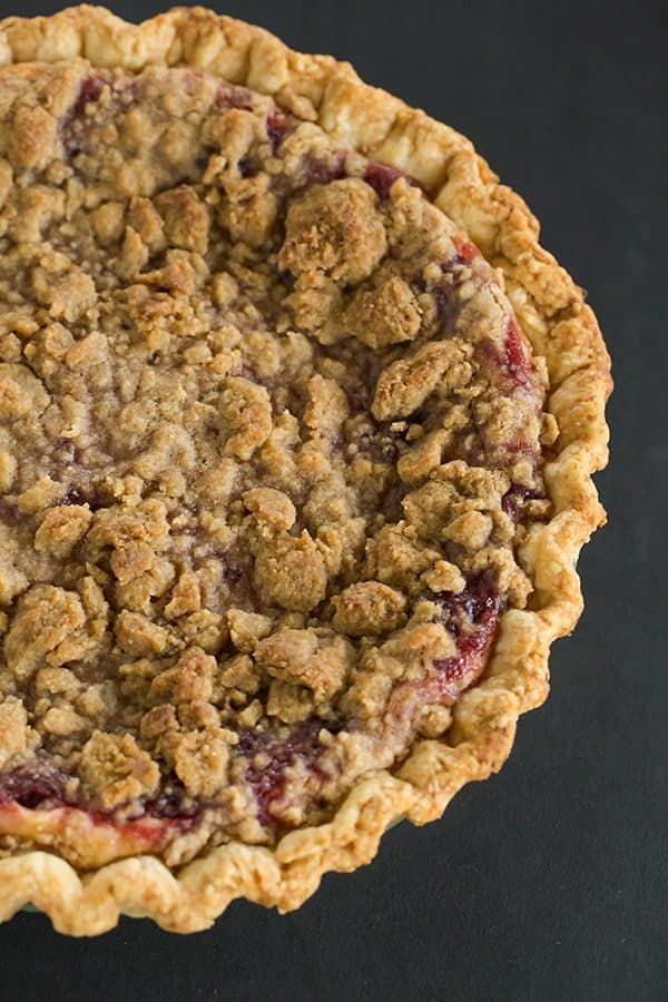 This Cranberry Cheesecake Crumb Pie features pie crust filled with a simple cheesecake batter, then topped with a thick cranberry sauce and crumb topping.
