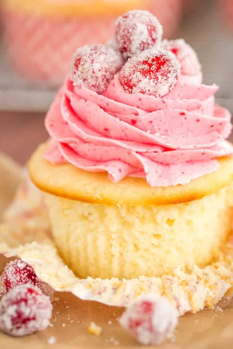 Sparkling Cranberry White Chocolate Cupcakes - Vanilla cupcakes with white chocolate ganache filling and cranberry buttercream frosting. | browneyedbaker.com