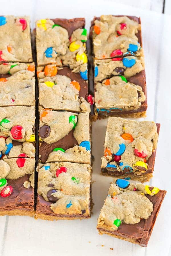 Monster cookie bars with the classic combination of peanut butter, oats, and M&Ms, plus a layer of fudge running through the center!