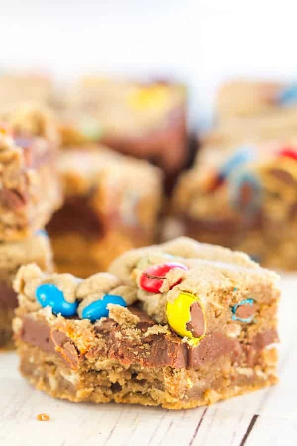 Monster cookie bars with the classic combination of peanut butter, oats, and M&Ms, plus a layer of fudge running through the center!