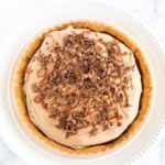 Milky Way Tart - A pate sucree crust is filled with caramel sauce and whipped milk chocolate ganache, then topped with a drizzle of caramel and chocolate curls.