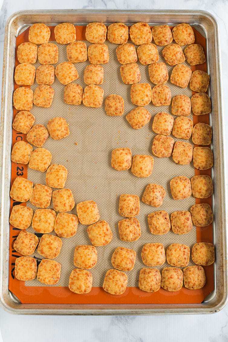 Baked homemade cheese crackers on the pan, right out of the oven.