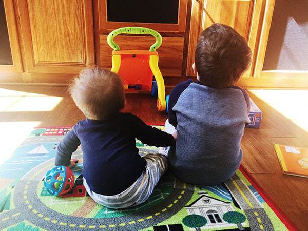 Joseph and Dominic sitting next to each other watching TV