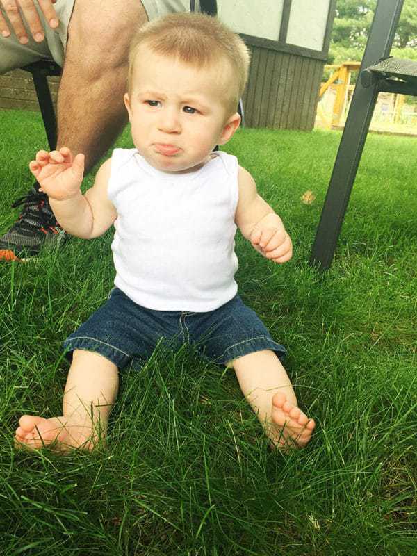 Dominic is not a fan of sitting in the grass