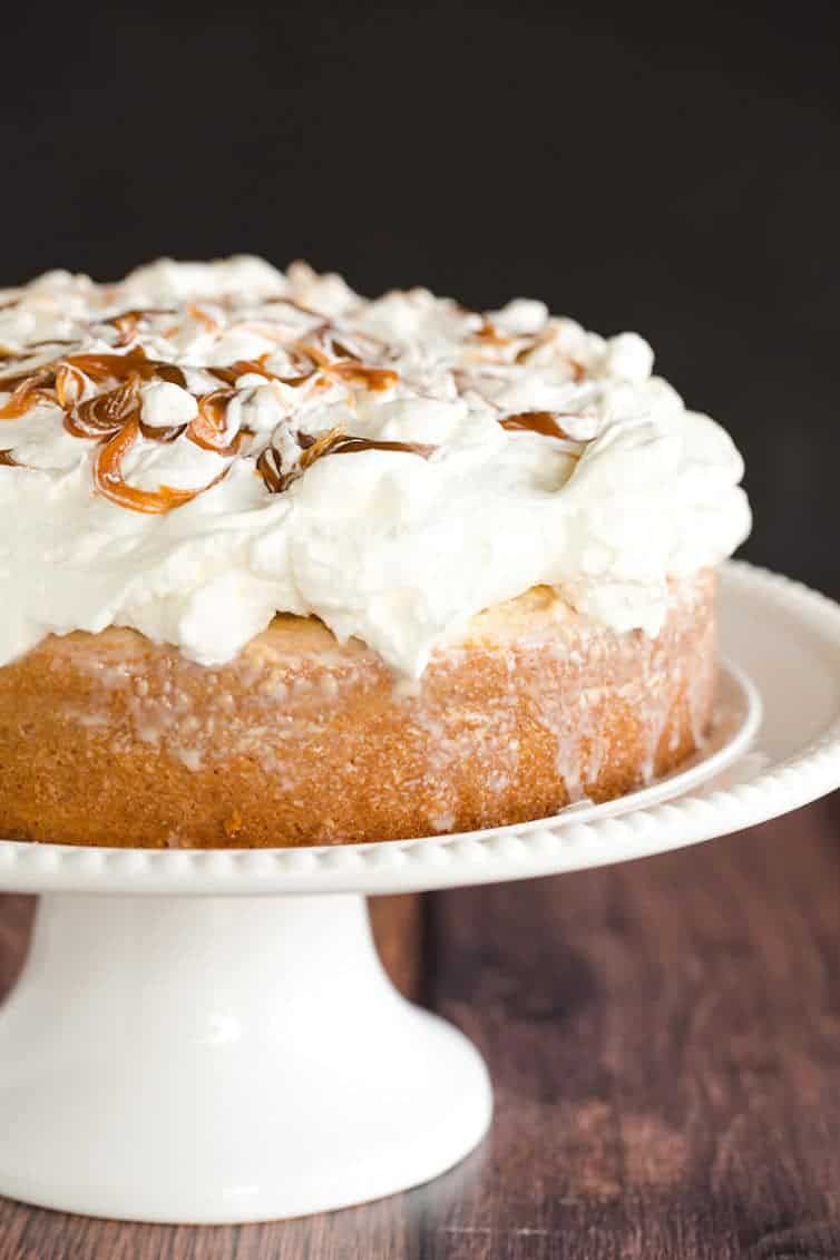 Caramel Tres Leches Cake topped with fresh whipped cream.