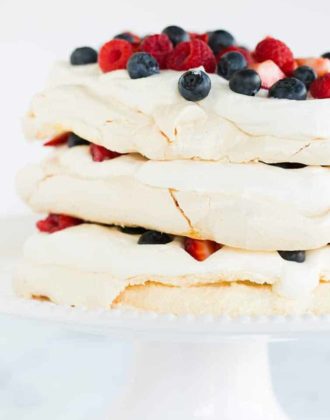 A closeup of pavlova layer cake on a cake stand.
