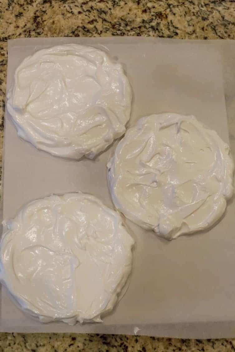 Circles of meringue ready to be baked into pavlova.