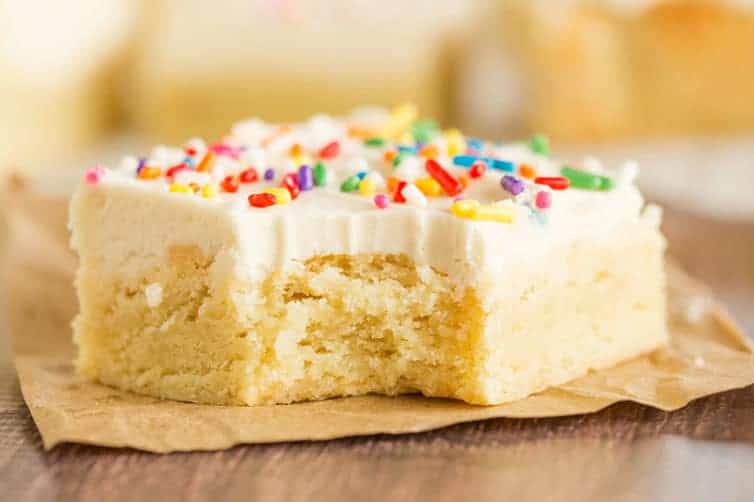 A sugar cookie bar with a big bite taken out of it.