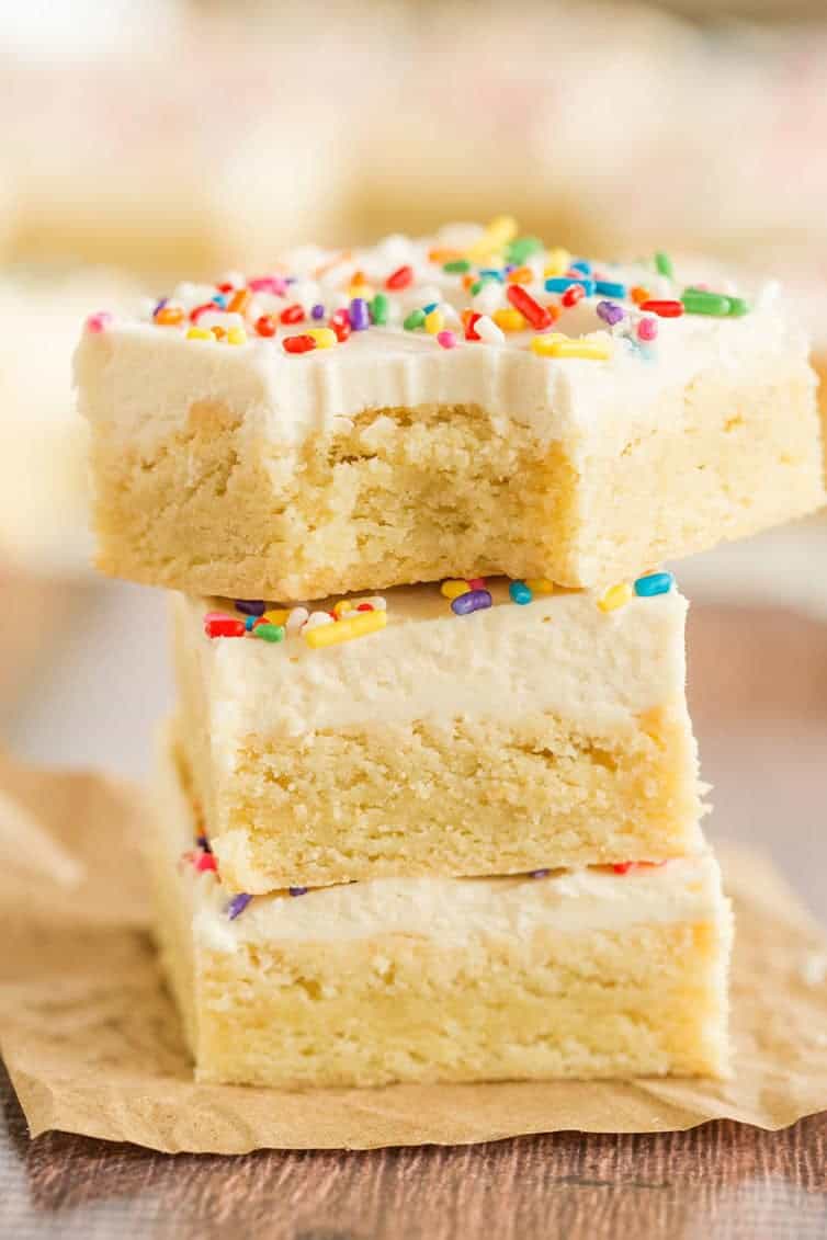 A stack of sugar cookie bars with a bite taken out of the top one!