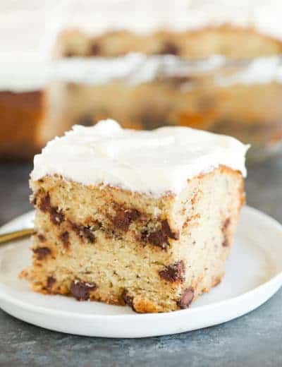 A beautiful slice of Banana-Chocolate Chip Snack Cake slathered with cream cheese frosting.
