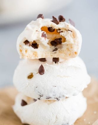 A stack of chocolate chip meringue cookies with a bite taken out!