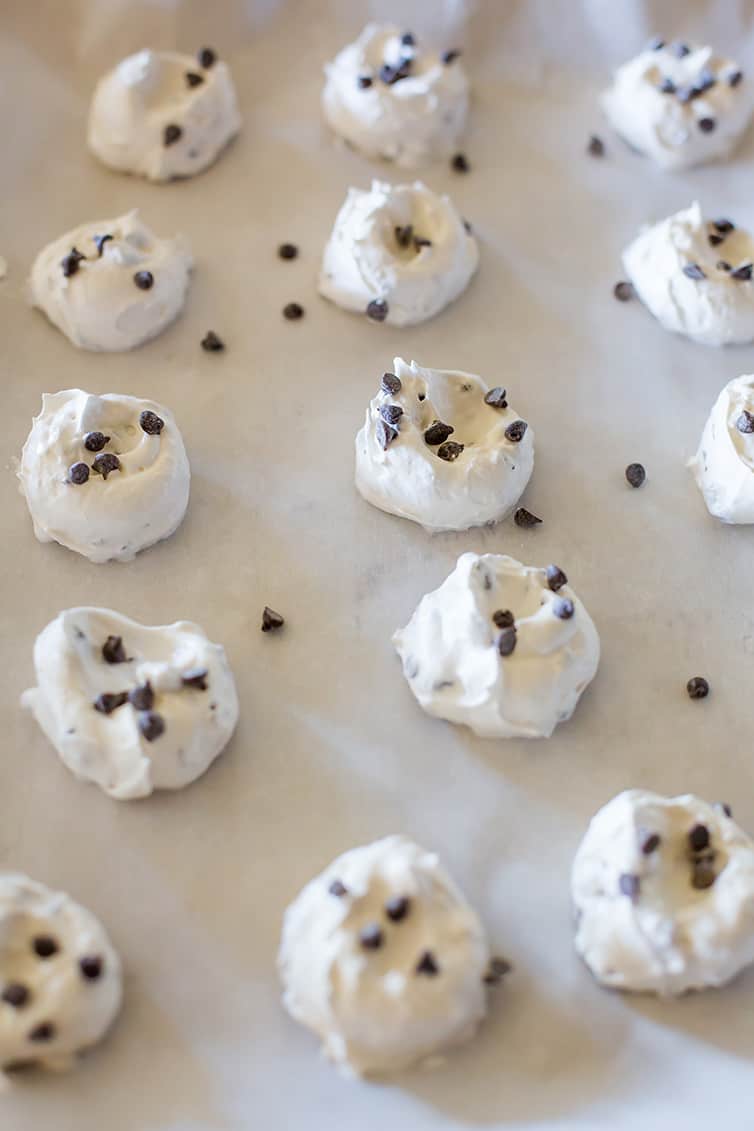 A tray of chocolate chip meringue cookies before baking.