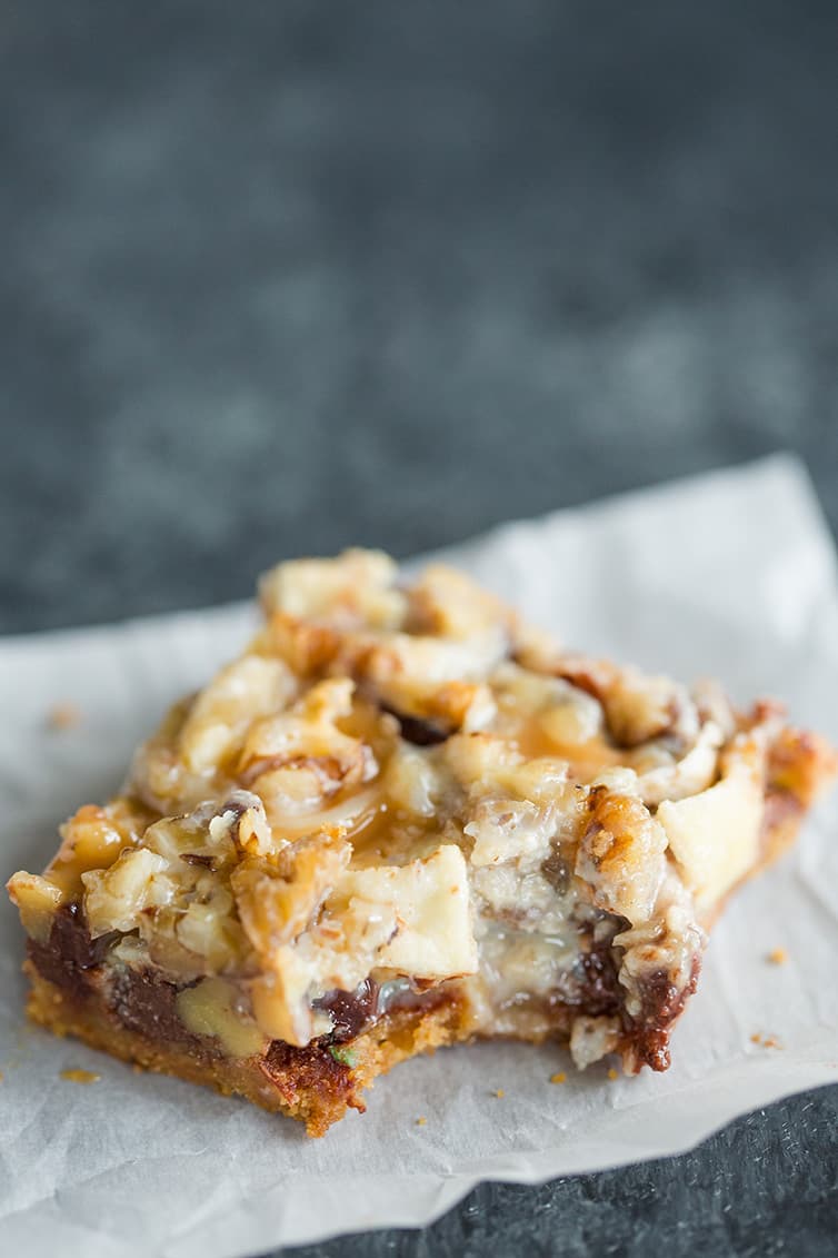 A caramel apple magic bar with a big bite taken out.