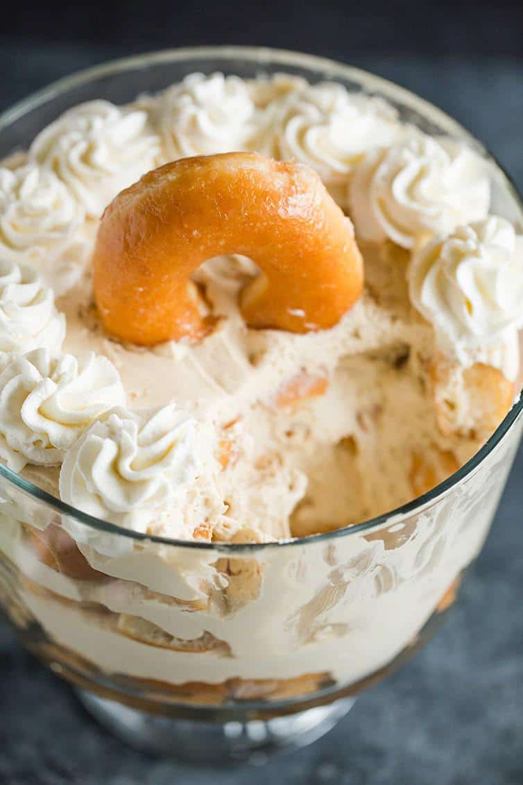 A coffee and doughnuts trifle with a big scoop taken out.