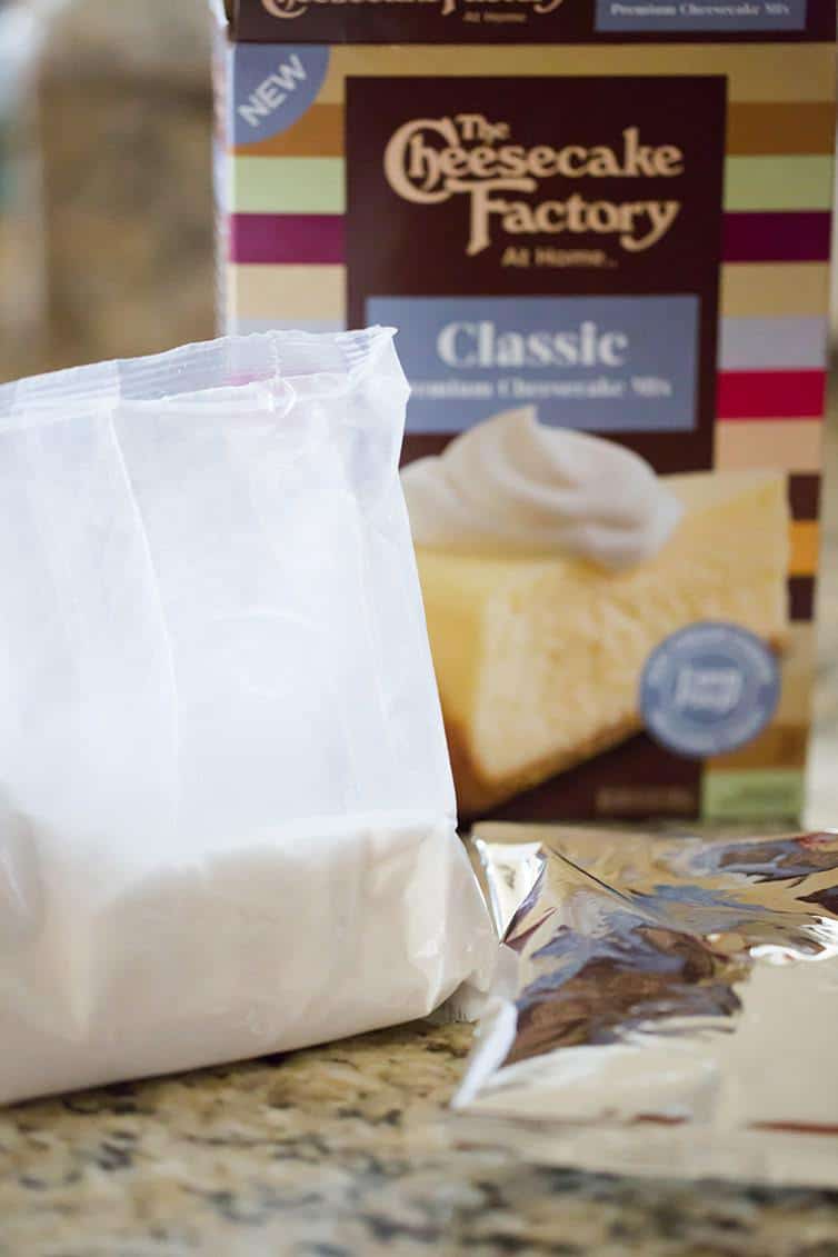 A box of The Cheesecake Factory At Home Cheesecake Mix with the pouches included.