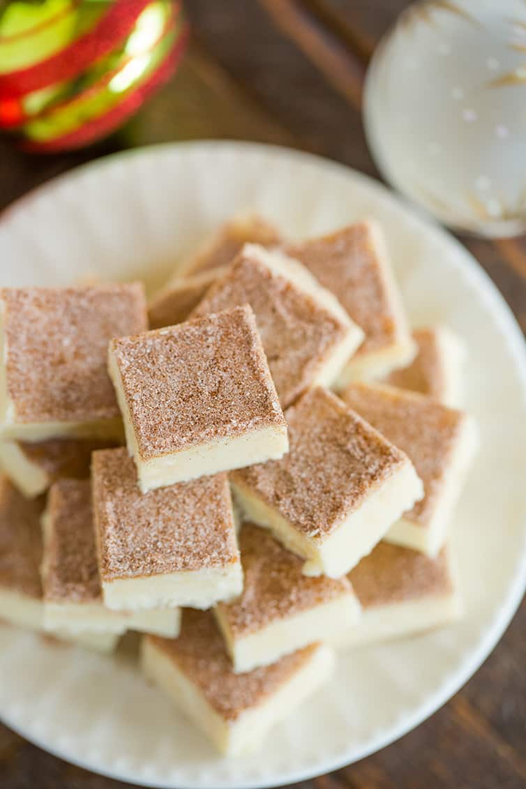 An overhead shot of a stack of snickerdoodle fudge on a white plate.