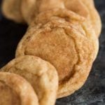 A display of snickerdoodle cookies on a dark serving plate.