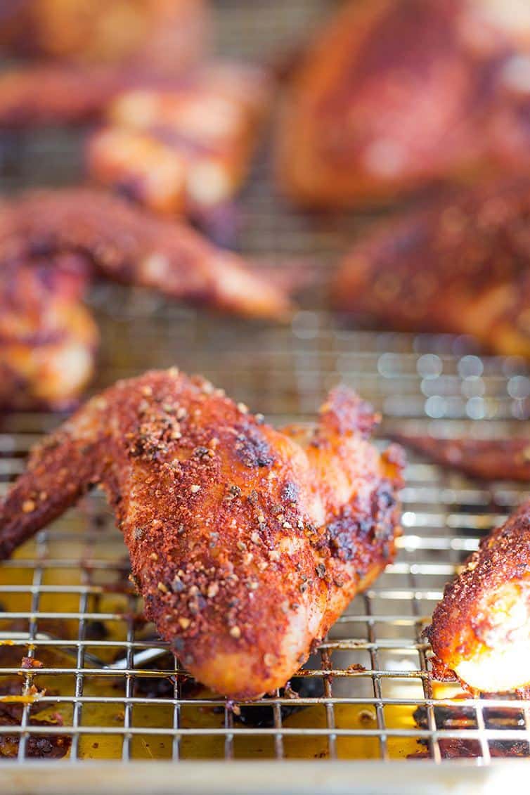 Baked chicken wings on a cooling rack.