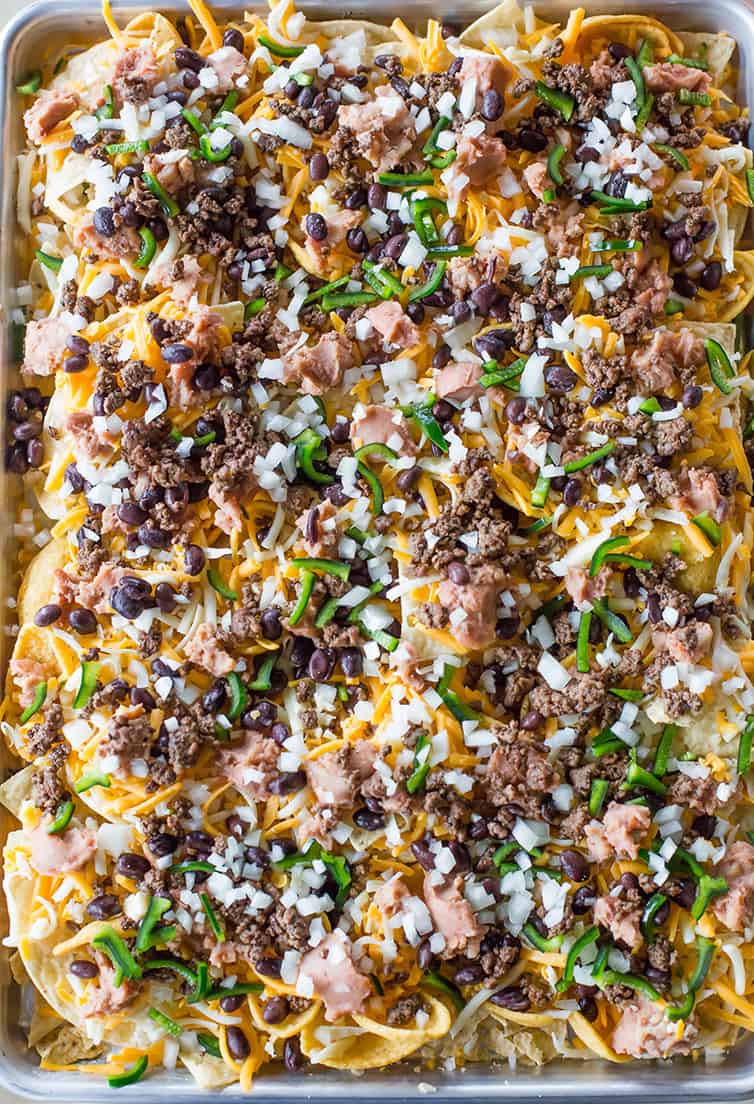 A sheet pan of nachos ready for the oven.